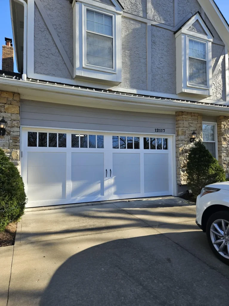 White carriage-style garage door with grid windows